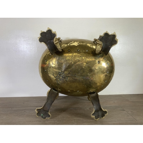 307 - A Victorian brass cauldron with lion paw supports and lion head design handles - approx. 37cm high x... 