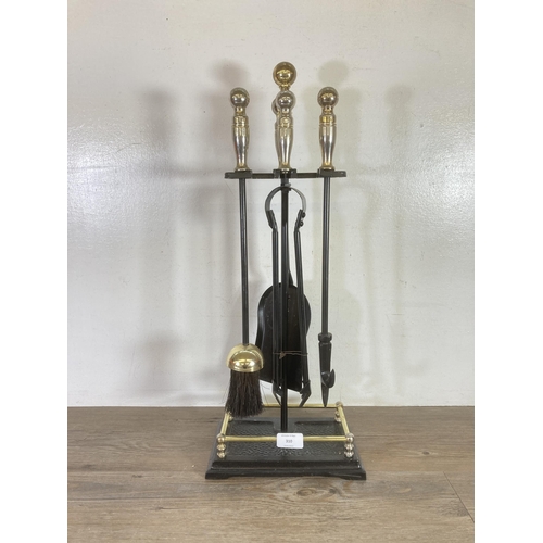 310 - A cast metal and brass effect fireside companion set - approx. 60cms high