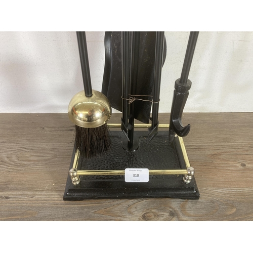 310 - A cast metal and brass effect fireside companion set - approx. 60cms high