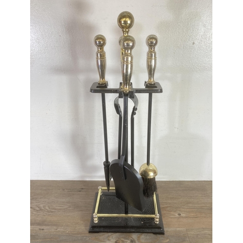 310 - A cast metal and brass effect fireside companion set - approx. 60cms high