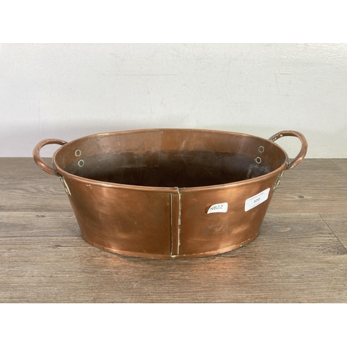 320 - A Victorian copper oval twin handled planter - approx 13cm high x 35.5cm wide x 19.5cm deep