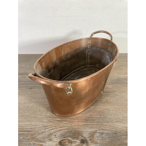 320 - A Victorian copper oval twin handled planter - approx 13cm high x 35.5cm wide x 19.5cm deep