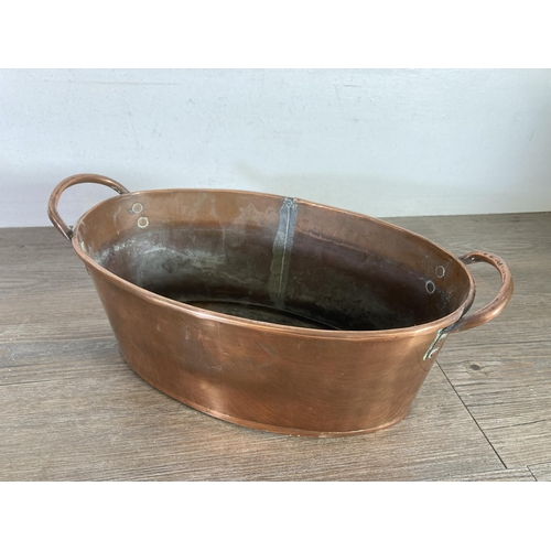 320 - A Victorian copper oval twin handled planter - approx 13cm high x 35.5cm wide x 19.5cm deep