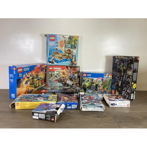 Twelve boxed Lego sets to include Lego City, Batman, Spiderman etc.