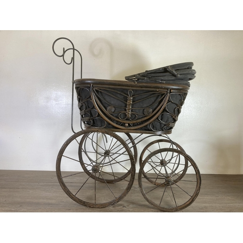 334 - A vintage cast metal and wicker dolls pram