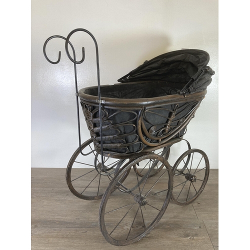 334 - A vintage cast metal and wicker dolls pram