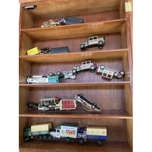 340 - Nine hardwood display cases containing a large collection of various diecast model vehicles