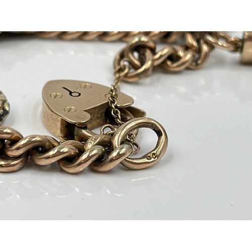 1119 - A late 19th/early 20th century 9ct gold bracelet with 9ct gold heart shaped padlock clasp and seven ... 