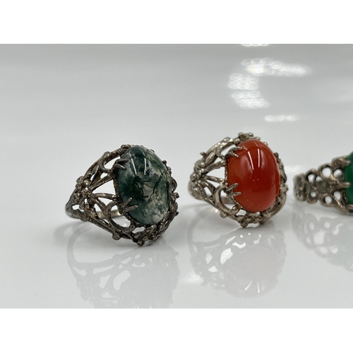 1134 - Four stamped silver gemstone solitaire rings to include moss agate, carnelian etc.