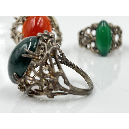 1134 - Four stamped silver gemstone solitaire rings to include moss agate, carnelian etc.