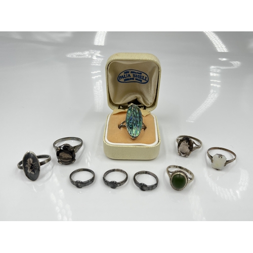 1140 - Nine sterling silver rings to include 9ct and silver opal, abalone etc.