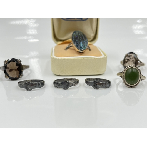 1140 - Nine sterling silver rings to include 9ct and silver opal, abalone etc.