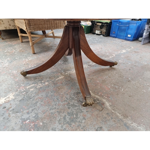 158 - A Regency style mahogany drum table with green leather insert and brass lion paw supports - approx. ... 