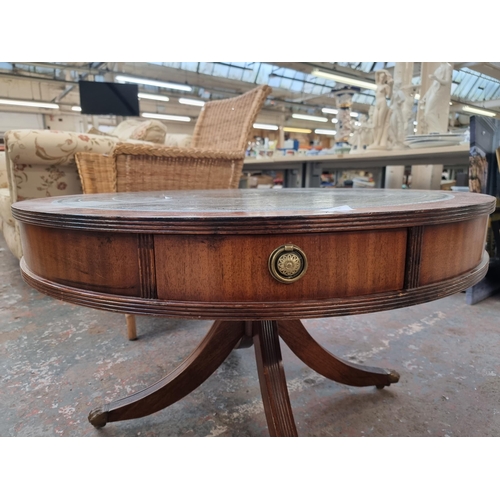 158 - A Regency style mahogany drum table with green leather insert and brass lion paw supports - approx. ... 