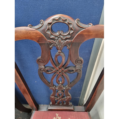 62B - A pair of Georgian style mahogany and tapestry upholstered dining chairs with ball and claw supports