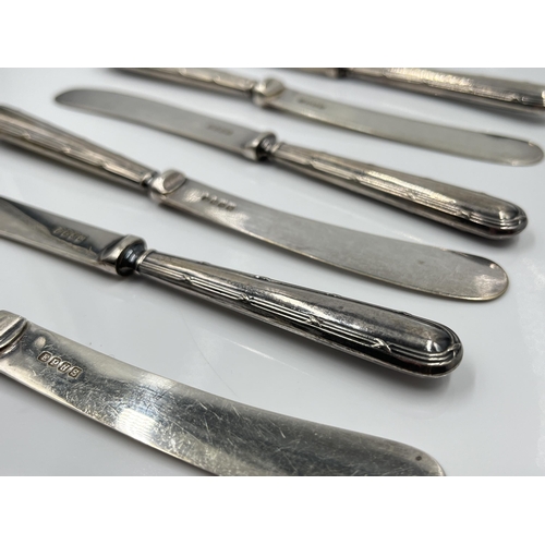 1250 - A cased set of six George V EPNS butter knives with hallmarked Sheffield silver handles, dated 1927 ... 