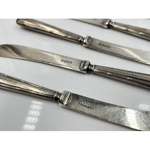 1250 - A cased set of six George V EPNS butter knives with hallmarked Sheffield silver handles, dated 1927 ... 