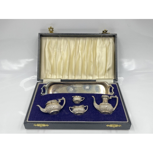 1251 - A cased Peter John Doherty hallmarked Birmingham silver five piece miniature tea/coffee service, dat... 