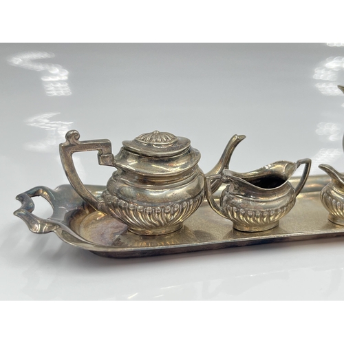 1251 - A cased Peter John Doherty hallmarked Birmingham silver five piece miniature tea/coffee service, dat... 