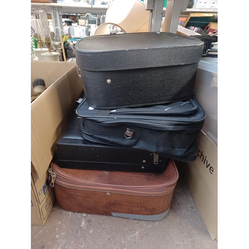 763A - Four boxes and four suitcases/briefcases containing a collection of assorted items to include crocod... 