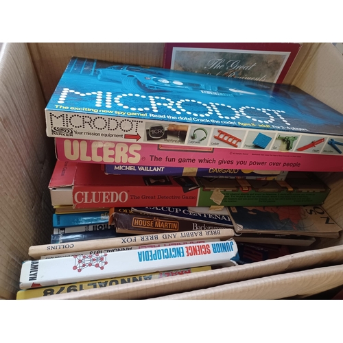 763B - Four boxes containing a collection of assorted items to include vintage board games, vintage books, ... 