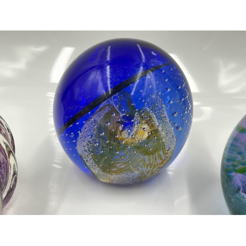 215 - Five studio glass paperweights, one Tutbury and four Caithness to include Nimbus limited edition 396... 