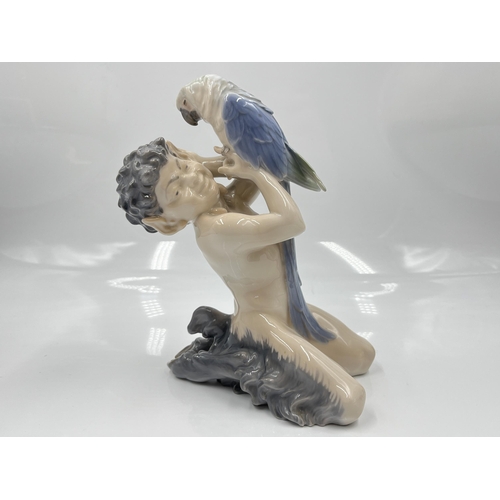 225 - A Royal Copenhagen Faun with Parrot figurine, model no. 752 - approx. 18cm high