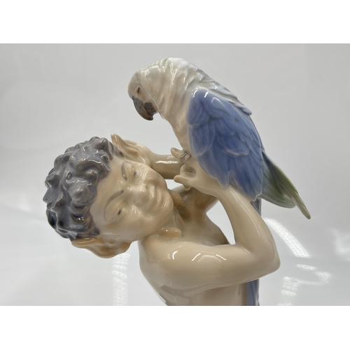 225 - A Royal Copenhagen Faun with Parrot figurine, model no. 752 - approx. 18cm high