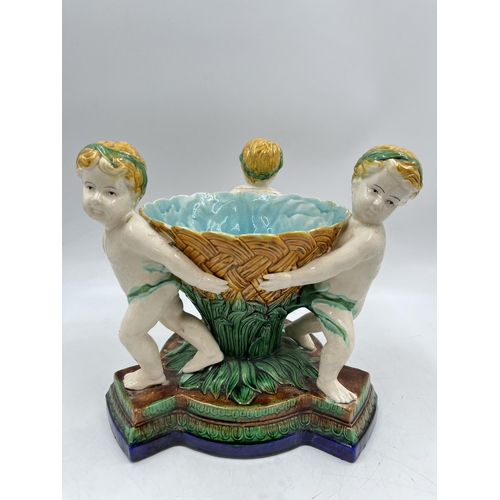 231 - A 19th century style Majolica triple cherub centre piece bowl - approx. 27cm high