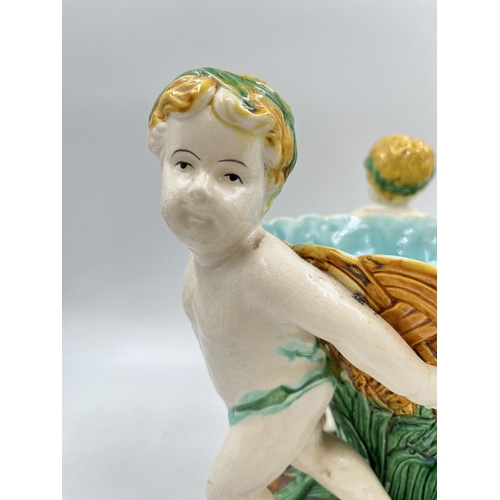 231 - A 19th century style Majolica triple cherub centre piece bowl - approx. 27cm high