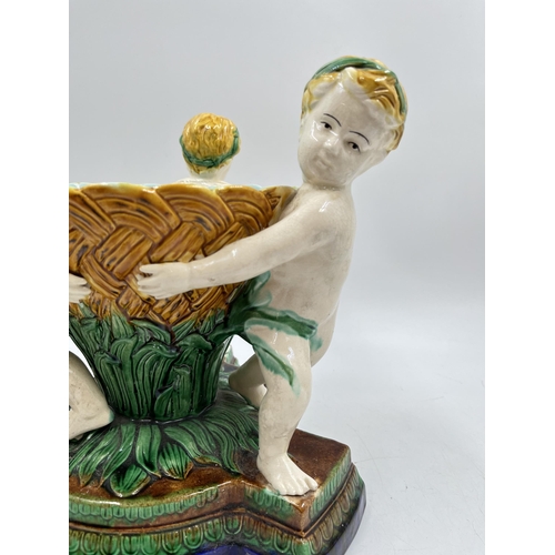 231 - A 19th century style Majolica triple cherub centre piece bowl - approx. 27cm high