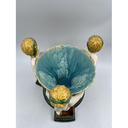 231 - A 19th century style Majolica triple cherub centre piece bowl - approx. 27cm high