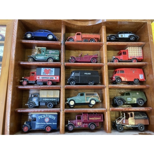 339 - Nine hardwood display cases containing a large collection of various diecast model vehicles