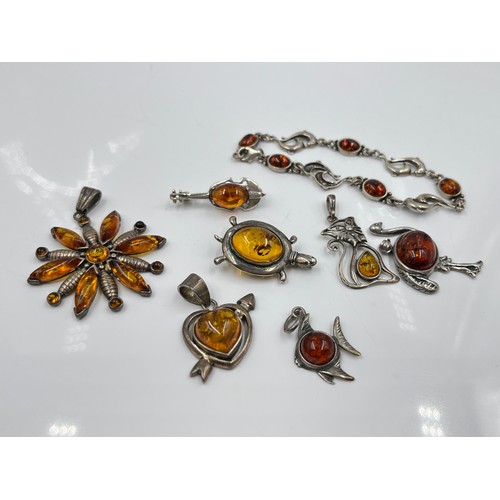 1094 - Eight pieces of .925 silver amber jewellery to include brooches, pendants etc. - approx. gross weigh... 