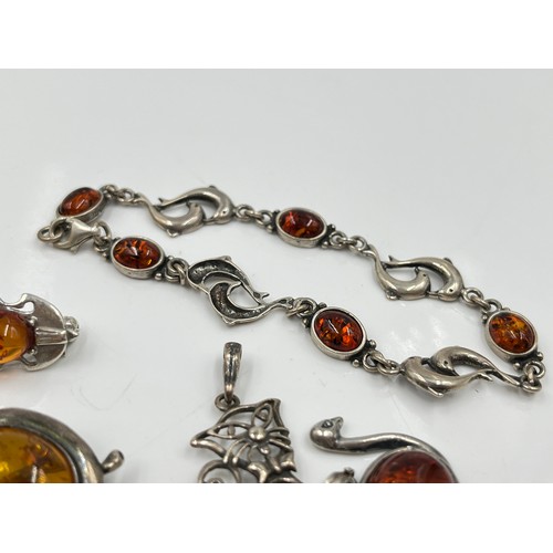 1094 - Eight pieces of .925 silver amber jewellery to include brooches, pendants etc. - approx. gross weigh... 