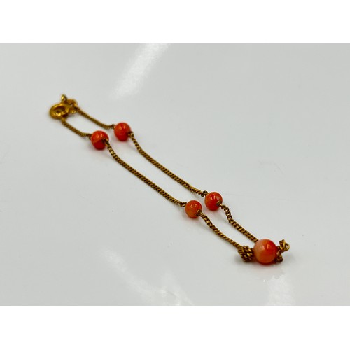 1130 - Two pieces of 9ct gold jewellery, one coral beaded bracelet and one pendant - approx. gross weight 2... 