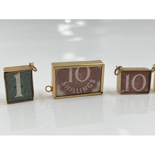 1143 - Four 9ct gold cased emergency money charms - approx. gross weight 10.71 grams