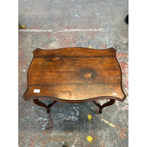 139A - An Edwardian mahogany serpentine two tier side table