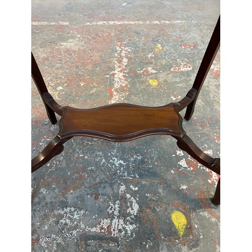 139A - An Edwardian mahogany serpentine two tier side table