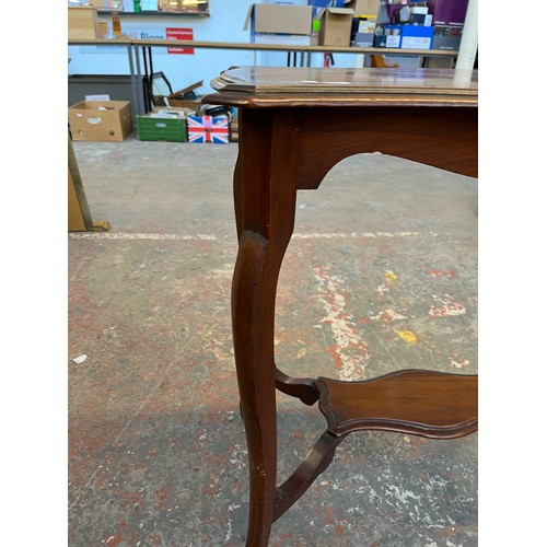 139A - An Edwardian mahogany serpentine two tier side table