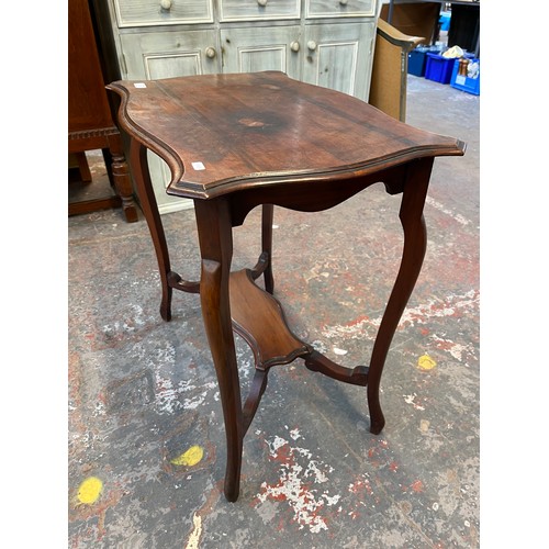 139A - An Edwardian mahogany serpentine two tier side table