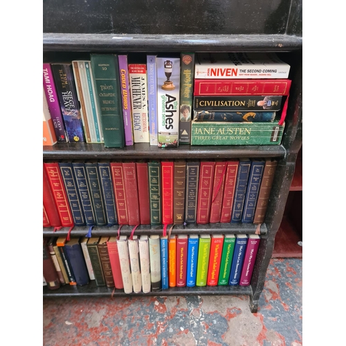 45F - A mid 20th century oak four tier bookcase containing books - approx. 93cm high x 91cm wide x 19cm de... 