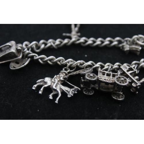 1154B - A .925 silver charm bracelet with assorted charms - approx. gross weight 45 grams