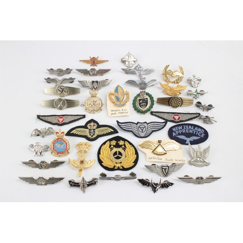 1250 - A collection of Air Force badges to include Austria, Angola, Hong Kong etc.