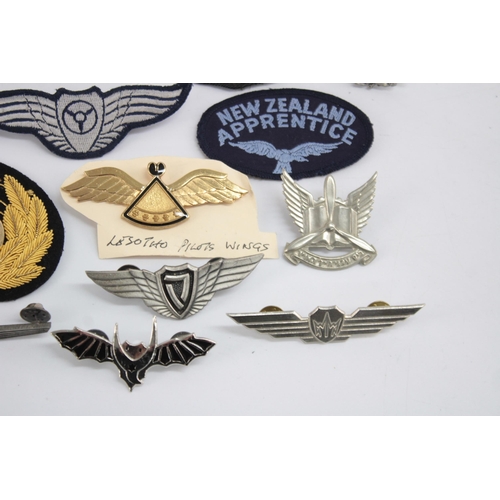 1250 - A collection of Air Force badges to include Austria, Angola, Hong Kong etc.