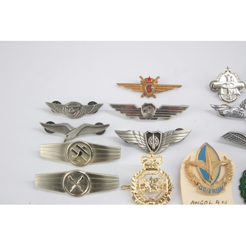 1250 - A collection of Air Force badges to include Austria, Angola, Hong Kong etc.