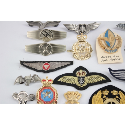 1250 - A collection of Air Force badges to include Austria, Angola, Hong Kong etc.