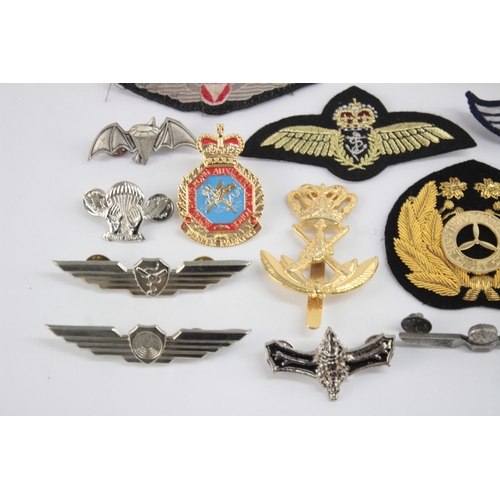 1250 - A collection of Air Force badges to include Austria, Angola, Hong Kong etc.