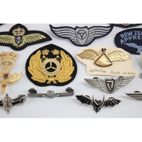 1250 - A collection of Air Force badges to include Austria, Angola, Hong Kong etc.