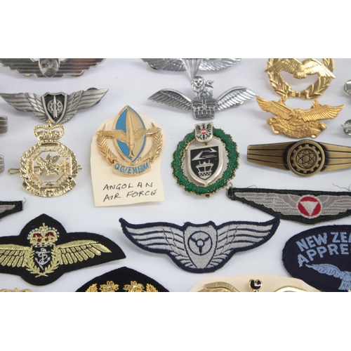 1250 - A collection of Air Force badges to include Austria, Angola, Hong Kong etc.